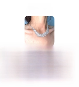 Detailed view of high-quality rhinestone fringe necklace with shimmering silver-tone plating
