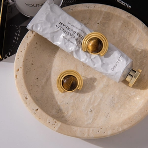 Detailed view of 18K gold plated stainless steel stud earrings with natural tiger eye stone