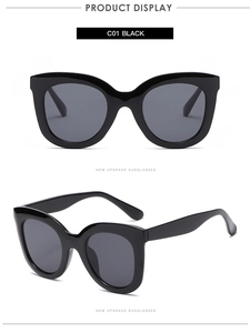 Front and side views of oversized glossy black cat-eye sunglasses with dark grey lenses