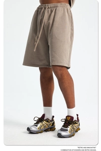 Detail of khaki cotton sweatshorts showing drawstring waist and premium knit texture