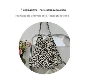 Detail of cotton leopard print canvas tote bag with a white MISS woven side label