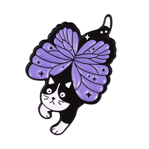 Detail of a black and white enamel cat brooch with purple butterfly wings for Halloween