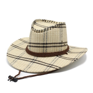 Close-up of cream straw cowboy hat with dark plaid pattern and brown adjustable chin strap