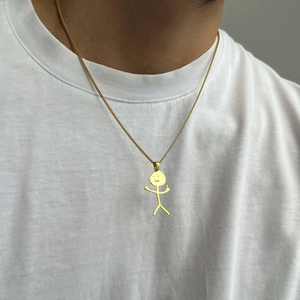 Funny gold doodle necklace featuring a minimalist middle finger stickman pendant on a model