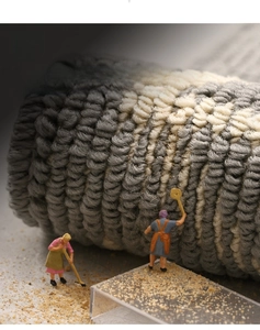 Close-up of durable gray geometric loop pile mat with sand scraping texture detail