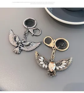 Detailed view of vintage eagle keychains with opal inlay and ornate wing textures