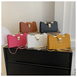 Close-up of stylish quilted crossbody bags in five colors with gold chain straps