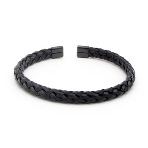 Macro detail of black braided wire stainless steel cuff bracelet with square metal ends