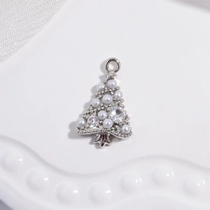 Macro shot of a silver metal Christmas tree pendant with pearls and rhinestones decoration