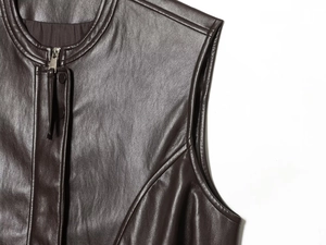 Detail of chocolate leather vest showing stand collar with premium zipper and stitching