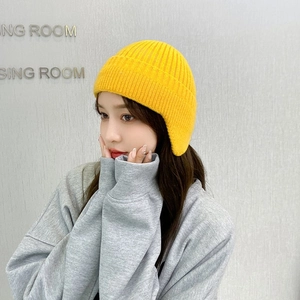 Winter yellow knit earflap hat with thick windproof thermal lining for cold weather
