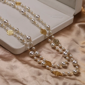 Elegant long necklace with white pearls and gold hollow camellia flower pendants