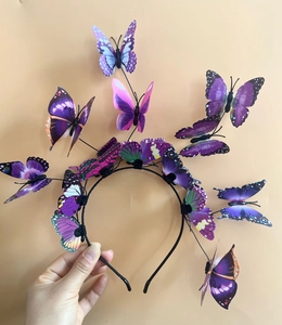 Detailed view of handmade 3D butterfly headband with colorful wings for festive parties