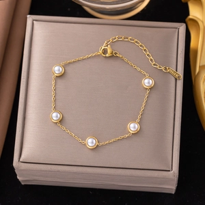 Elegant gold stainless steel pearl bracelet set on a premium jewelry display box