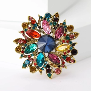 Macro shot of vintage floral brooch with colorful crystals and gold-plated alloy base