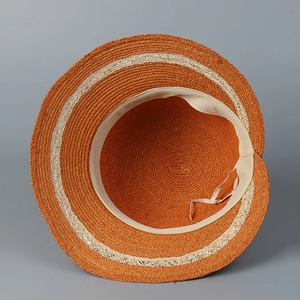 Close-up of orange raffia sun hat interior with sweatband and adjustable drawstring