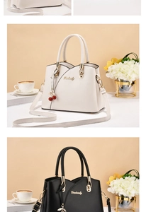 Detail of elegant PU leather handbag with gold Danbaoly logo and cherry pendant