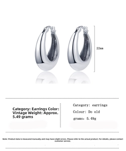 Macro detail of vintage S925 silver U-shaped earrings with 22mm height and 5.49g weight