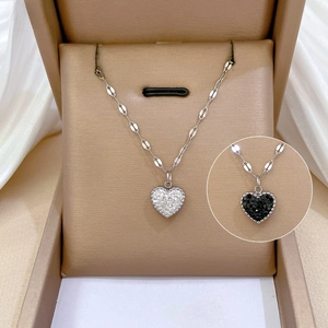 Detail showing heart-shaped micro-pave zircon necklace in gold and black variants