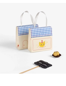 Detail of cute gift paper bag with silk handles and cartoon cat design for candies