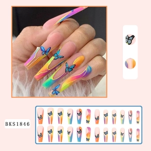 Detail of long coffin nails with blue butterfly patterns and rainbow gradient finish