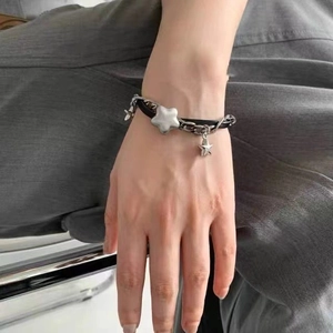 Chunky silver star pendant bracelet on black cord for Y2K minimalist streetwear style