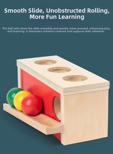 Detail of wooden Montessori toy box with three colorful balls on a blue background