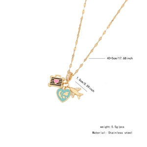 Detail showing gold travel charms with suitcase, heart map and plane on stainless chain