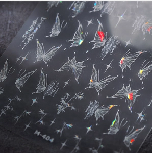 Detail of M-404 laser nail stickers with butterfly, star, and bamboo foil patterns