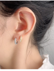 Close-up of model wearing mini S925 sterling silver hoop earrings with white zircon