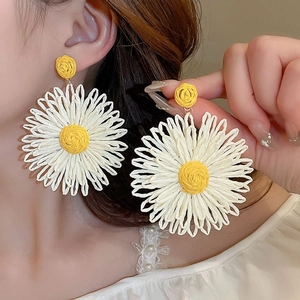 Handmade woven raffia daisy flower drop earrings for a seaside holiday summer look