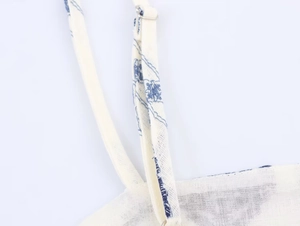 Detailed macro shot of blue floral print on linen fabric with adjustable silver buckle