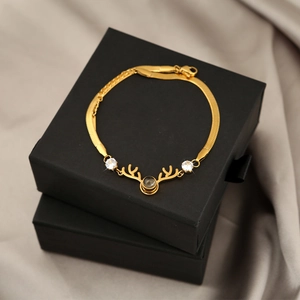 Luxurious gold deer antler bracelet with projection stone on black jewelry boxes