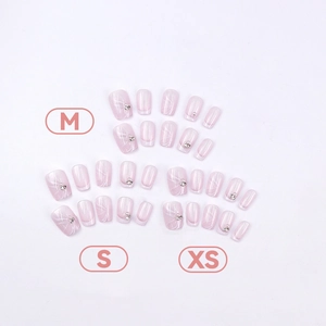 Pink press-on nail kit with pearl accents and marble patterns in M, S, and XS sizes