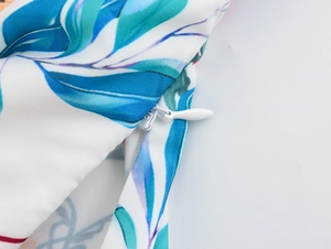 Close-up of high-quality fabric texture with floral print and white invisible zipper