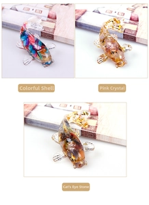 Detail of resin koi fish figurines with pink crystal, shell, and cat's eye stone inserts