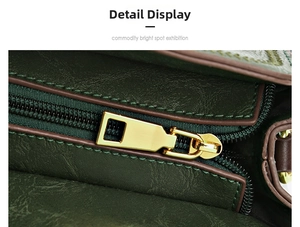 Detail shot of golden metal zipper and pebble grain leather on dark green bucket bag