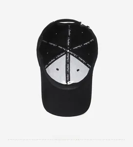 Interior detail of black baseball cap with i Fashion embroidery and stitched seams