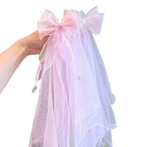 Pink princess tulle hair clip for girls with a large glitter bow and long elegant veil