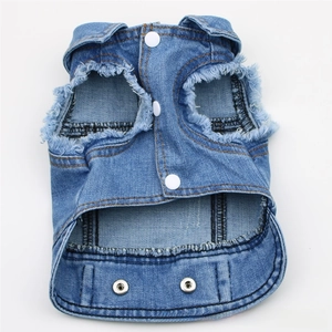 Detail of blue denim pet vest featuring distressed fringe edges and white snap buttons