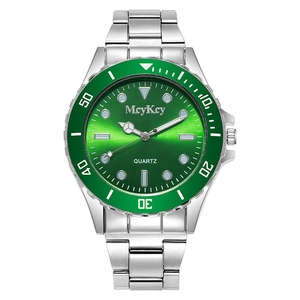 Macro shot of silver quartz watch featuring a green sunray dial and date display window