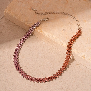 Detail of gradient rhinestone choker featuring purple to amber stones and lobster clasp