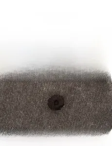 Detailed macro view of the embroidered eyelet on a distressed vintage baseball cap