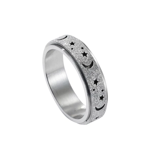 Silver fidget ring with rotating frosted band featuring hollow moon and star patterns