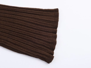 Macro close-up showing the dark brown ribbed knit fabric texture of the sleeve cuff