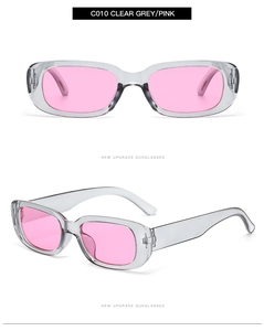 Detail view of transparent grey rectangular sunglasses with vibrant pink lenses