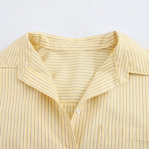 Detail view of the yellow and white striped shirt collar with fine textured fabric