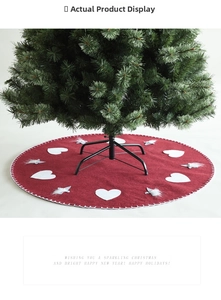 Detail of red wool felt Christmas tree skirt featuring a gnome with a white heart applique