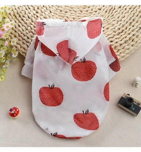 Detail view of pet sun protection hoodie with red apple print on white fabric