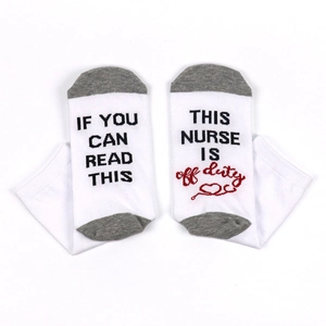 Detail of funny nurse socks with IF YOU CAN READ THIS text and stethoscope pattern